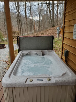 A hot tub with a control panel and a sign listing rules. - Hocking Hills (Buck Crossing Retreat) (Rockbridge)