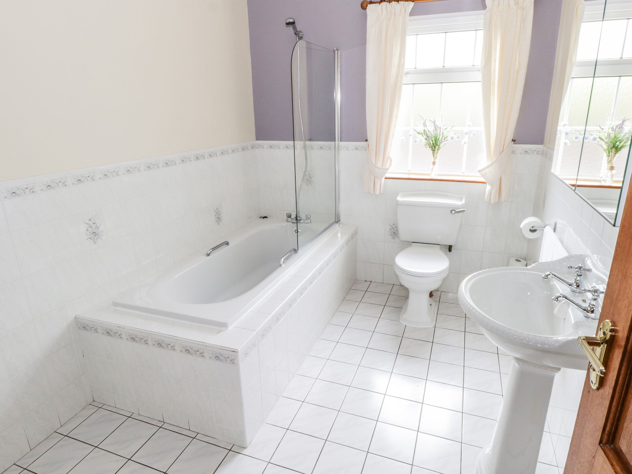 A bathroom with a bathtub, toilet, and sink.