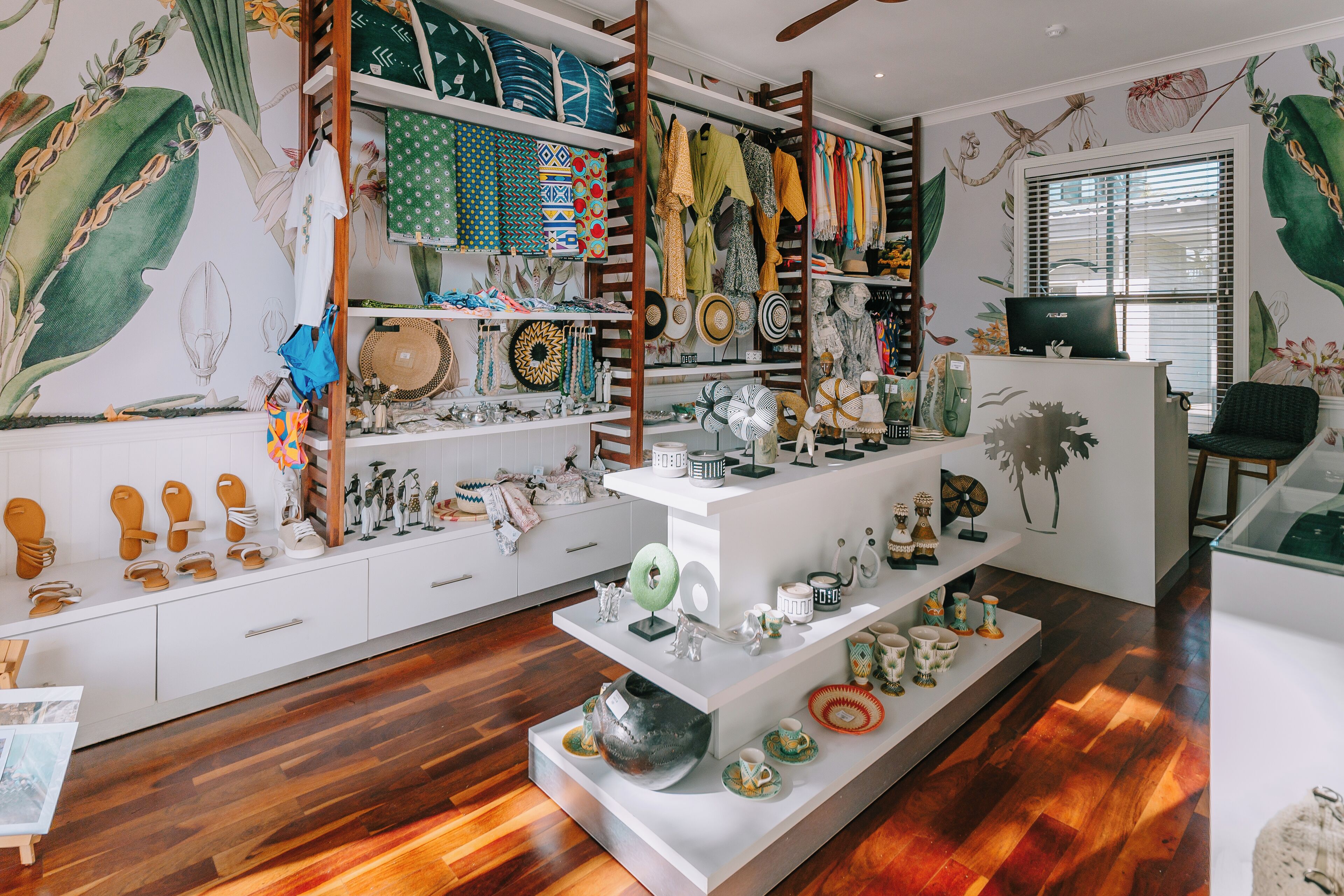 A well-organized store with shelves of textiles, ceramics, and decorative items.