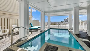 A pool area with a clear view of the ocean, white chairs, and a covered deck. - Gulf front home w/6 seater golf cart, priv. pool, direct beach access (Santa Rosa Beach)