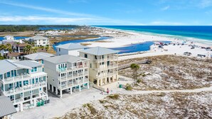 A beachfront hotel with multiple balconies, a sandy beach, and a clear view of the ocean. - Gulf front home w/6 seater golf cart, priv. pool, direct beach access (Santa Rosa Beach)