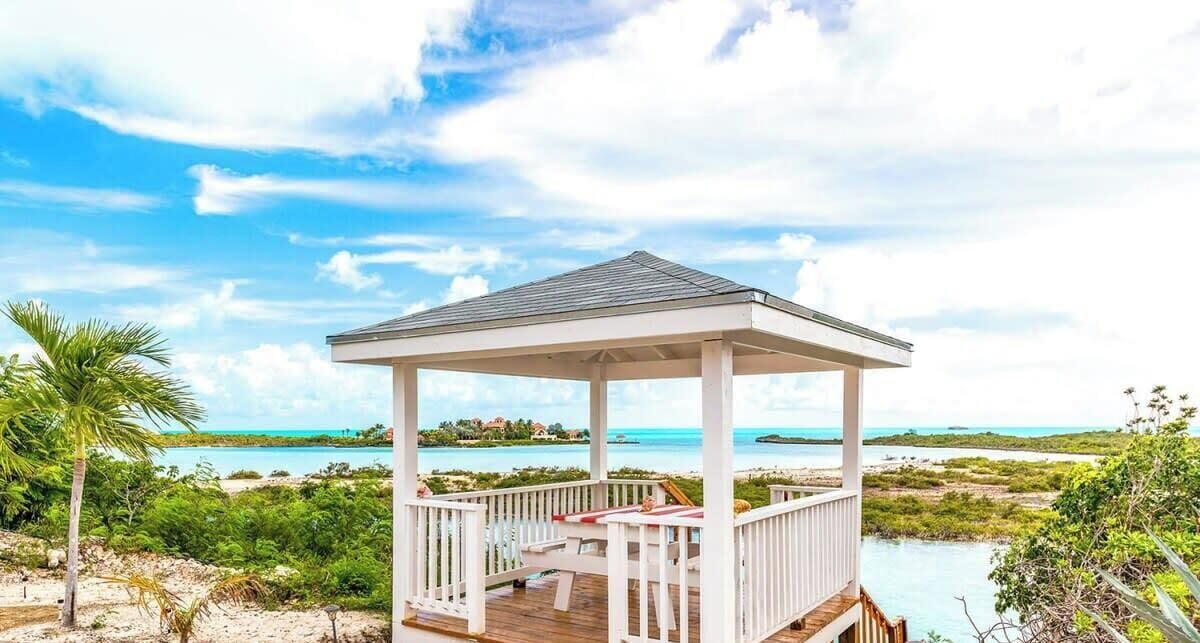 A gazebo with a view of a beach and ocean.