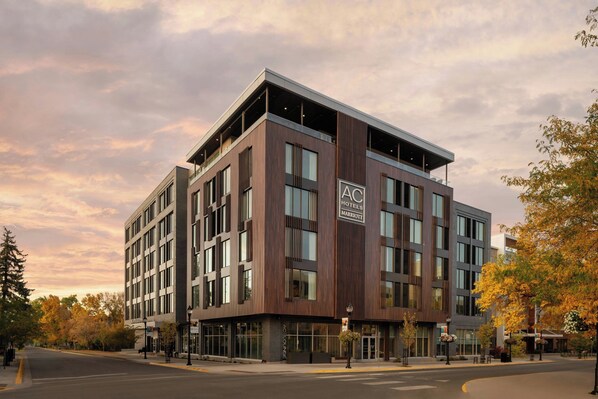 A modern hotel building with a prominent "AC Hotels Marriott" sign, large windows, and a flat roof. - AC Hotel Bozeman Downtown (Bozeman)
