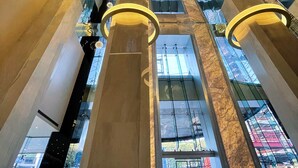 A high-ceiling atrium with reflective surfaces and modern lighting fixtures. - Safi Royal Luxury Metropolitan (San Pedro Garza García)