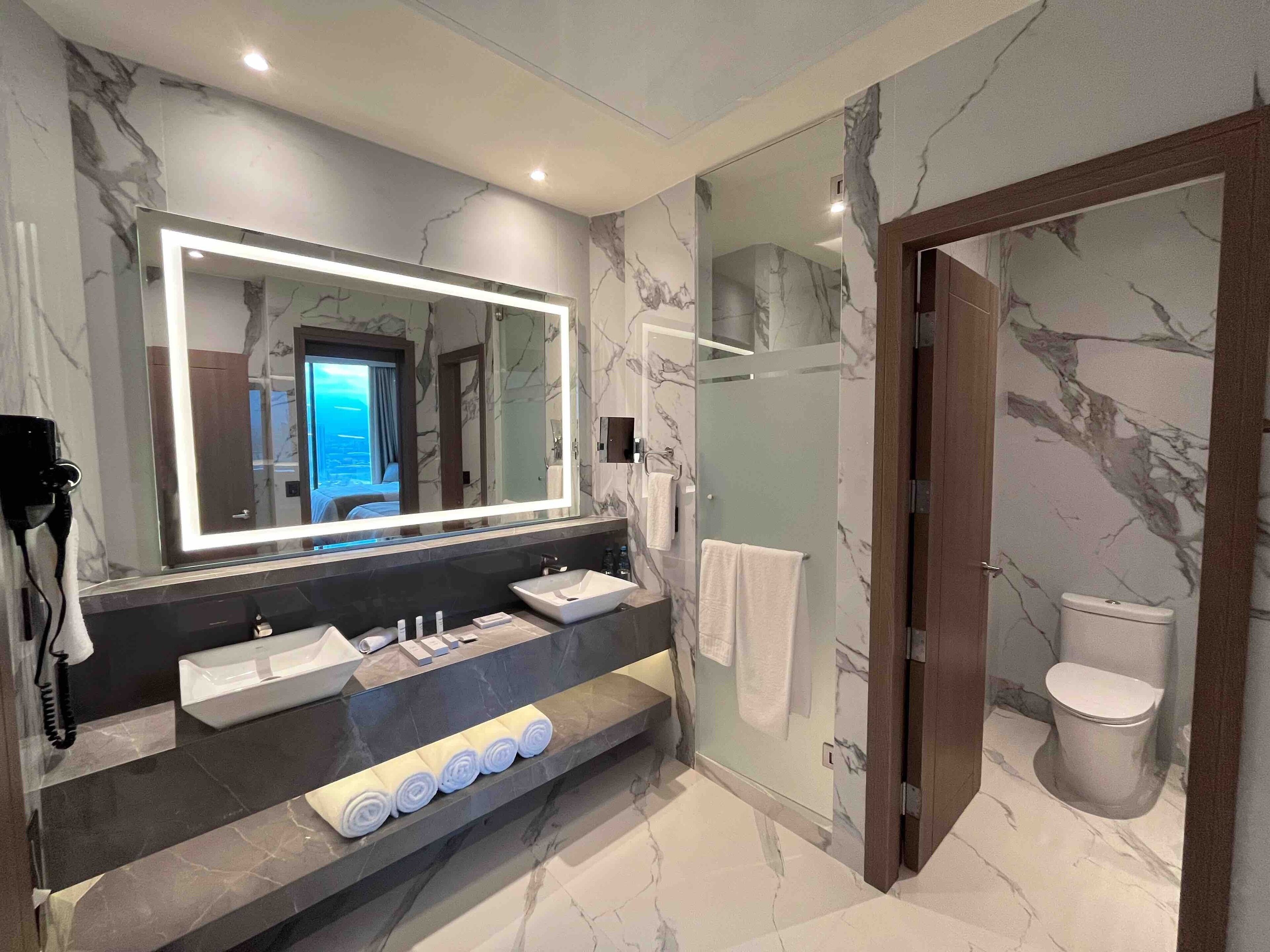 suite double queen | bathroom | shower, rainfall showerhead, hair dryer, towels