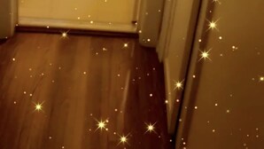 A narrow hallway with a white toilet and a sink, wooden flooring, and a door on the right. - Nice Condo for rent in Mid City LA (Los Angeles)