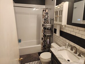 Combined shower/tub, hair dryer, towels, soap