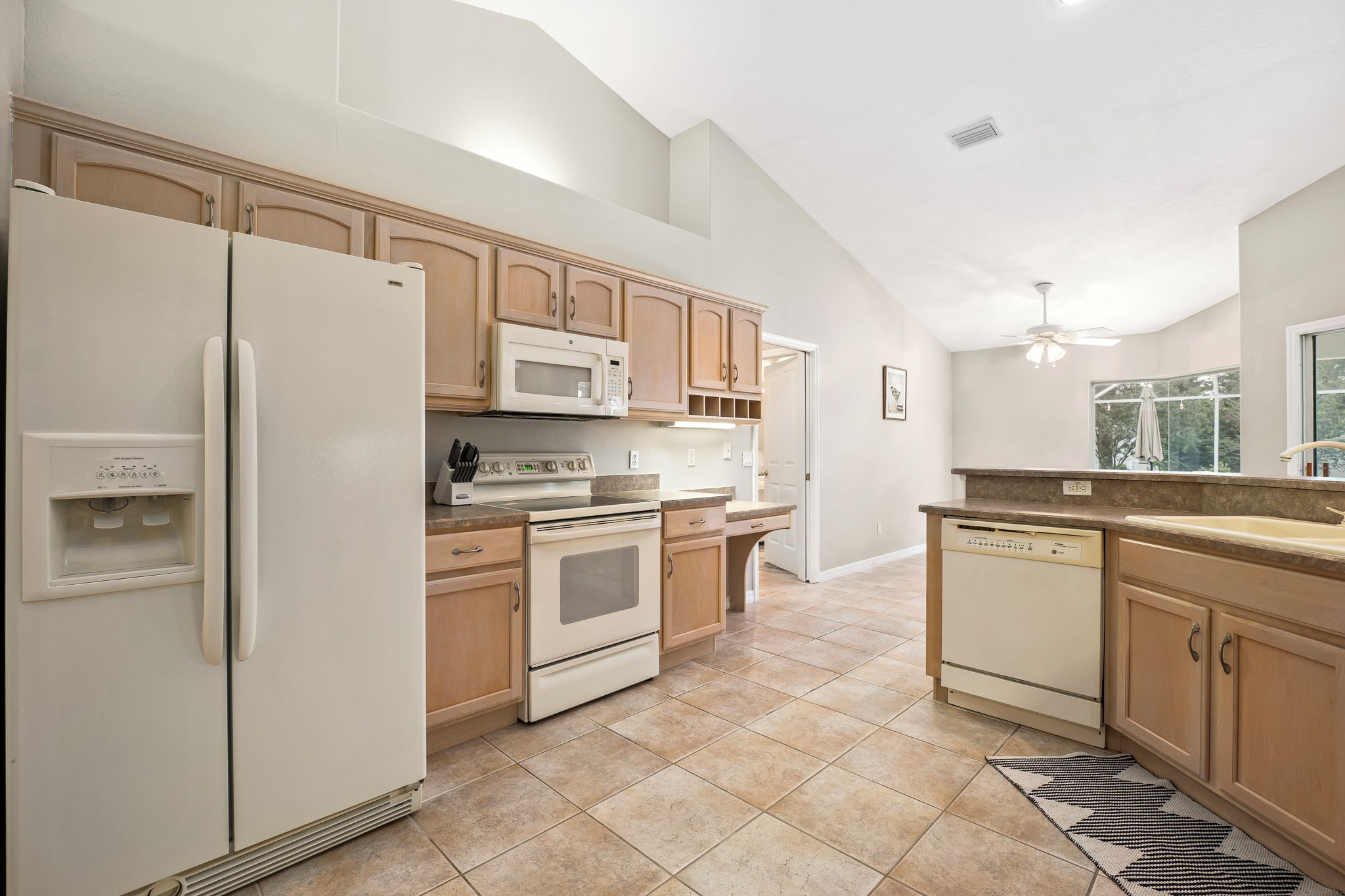 A kitchen with a refrigerator, microwave, stove, oven, and dishwasher.