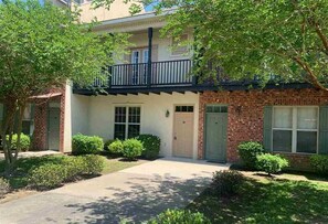 Stunning two-story residence with a central entrance and upper balcony.