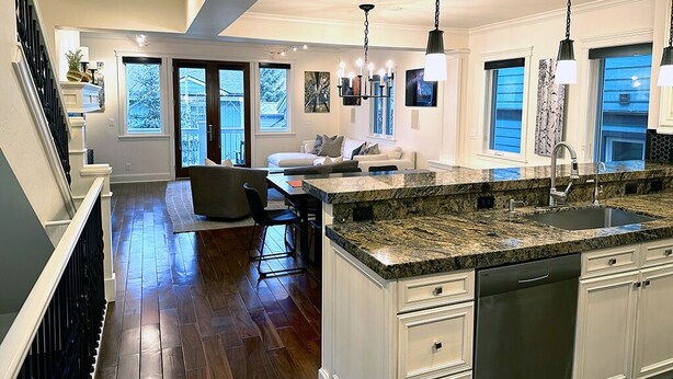 A spacious kitchen with granite countertops, a dishwasher, and a dining area with a sofa and chairs. - Luxury home; king ensuites, walk to lifts/main st (Park City)