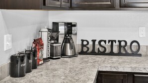 A kitchen counter with a coffee maker, a bag of coffee, and a 'BISTRO' sign. - Sweet as a Peach Family Home (Meridian)