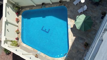 Outdoor pool, open 10:00 AM to 8:00 PM, pool umbrellas