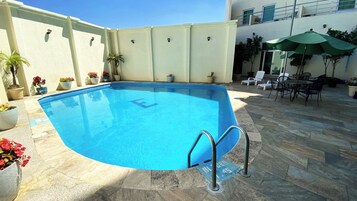 Outdoor pool, open 10:00 AM to 8:00 PM, pool umbrellas