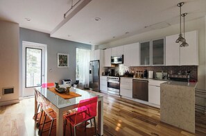Enjoy meals in the kitchen with a central island, dining area, and large window offering a view of the outdoors.