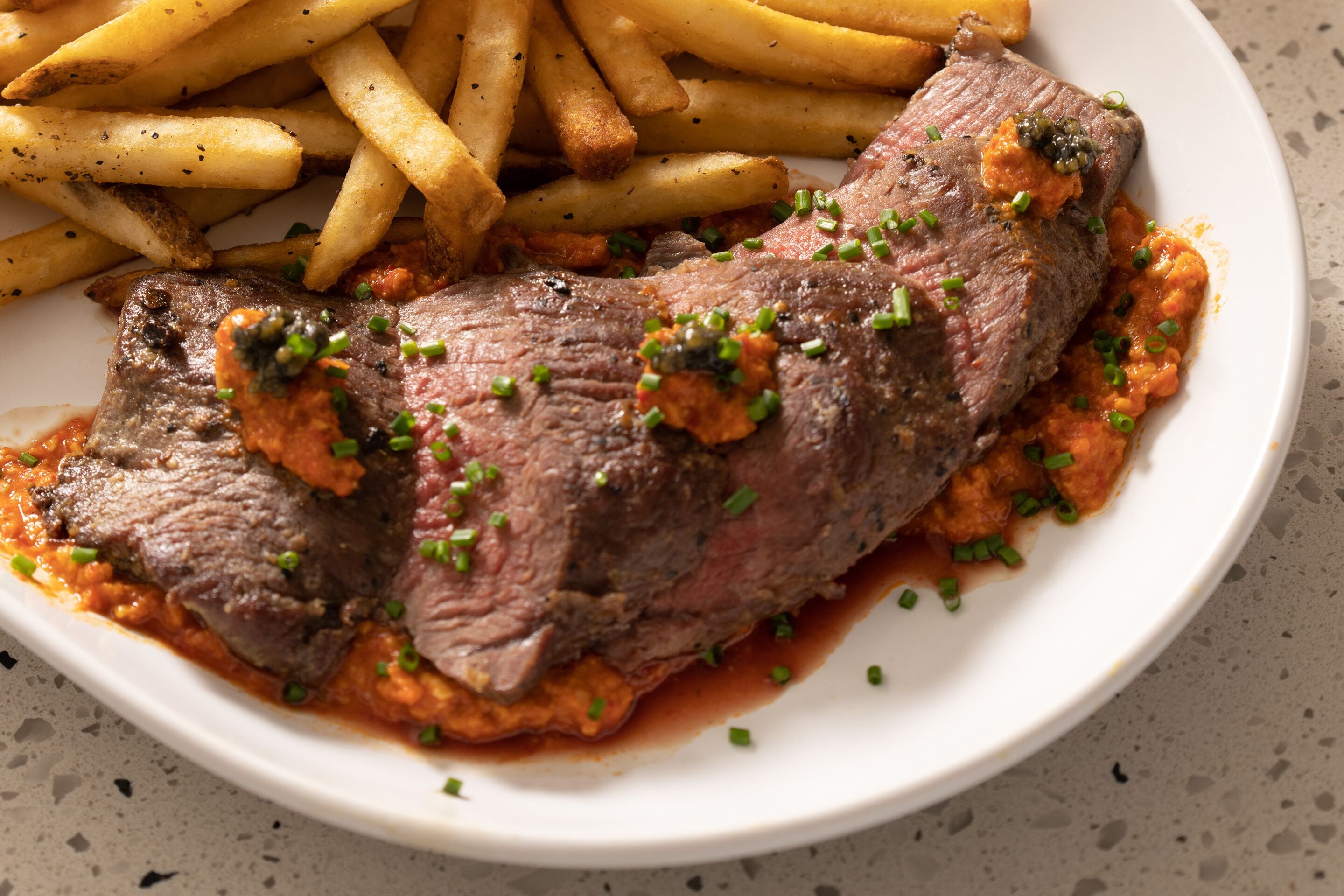 A plate with a steak and fries.