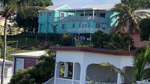 A two-story building with a balcony and a covered porch. - Maryville Studio (St.Thomas)