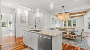 A modern kitchen with a central island, stainless steel appliances, and pendant lighting. - Bring Fido! Stylish 4BR Home in Eastern Lake (Santa Rosa Beach)