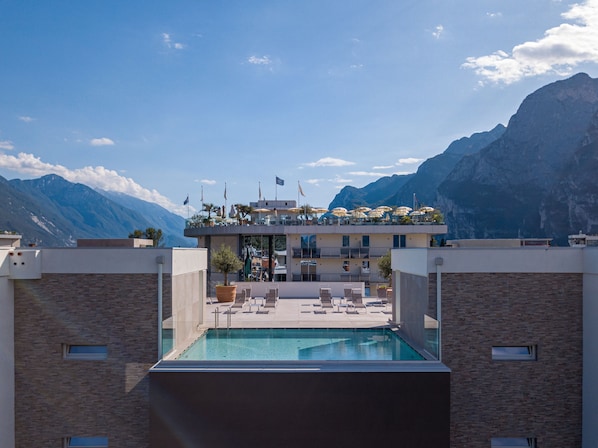 Seasonal outdoor pool, open 8:00 AM to 7:00 PM, pool umbrellas