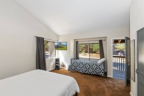 A bedroom with two beds, a TV, and a balcony with a view. - Walking Distance to Snow Summit Ski Resort!! Beautifully Updated 3 BED 2 BATH! Wood Burning Fireplace! Smart TVs w/ Streaming Services! (Big Bear Lake)