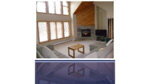 A spacious living room with a fireplace, large windows, and a cozy seating area. - THE PERFECT VERMONT GETAWAY (Dover)