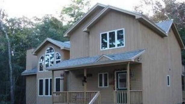 A two-story wooden cabin with a porch and a small staircase leading to the entrance. - THE PERFECT VERMONT GETAWAY (Dover)