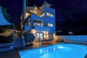 A modern two-story house with a swimming pool, outdoor seating, and a staircase leading to the upper level. - EVAERI villa - Tranquil getaway! (Artemis)