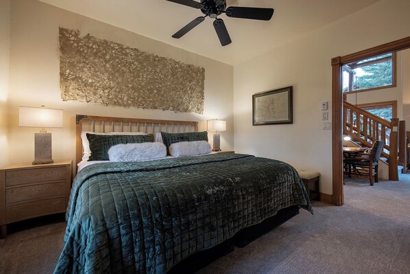 A bedroom with a bed, two bedside tables, a ceiling fan, a wall art piece, and a window with a view. - X2685 | Valley and Mtn Views | Nice Furnishings | Hot Tub | Pool | A/C (Steamboat Springs)
