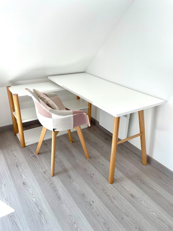 A corner room with a white desk, a cushioned chair, and a slanted ceiling. - Fenced-in 4-star house—direct access to the Etel River (300 meters) (Plouhinec)