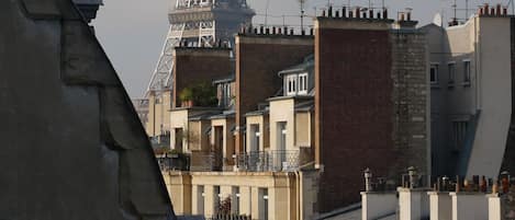 A view of the Eiffel Tower from a building with balconies.