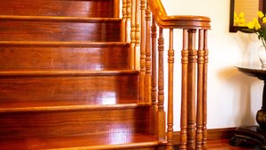 A wooden staircase with a handrail and balusters. - Holland Acres (Williamstown)