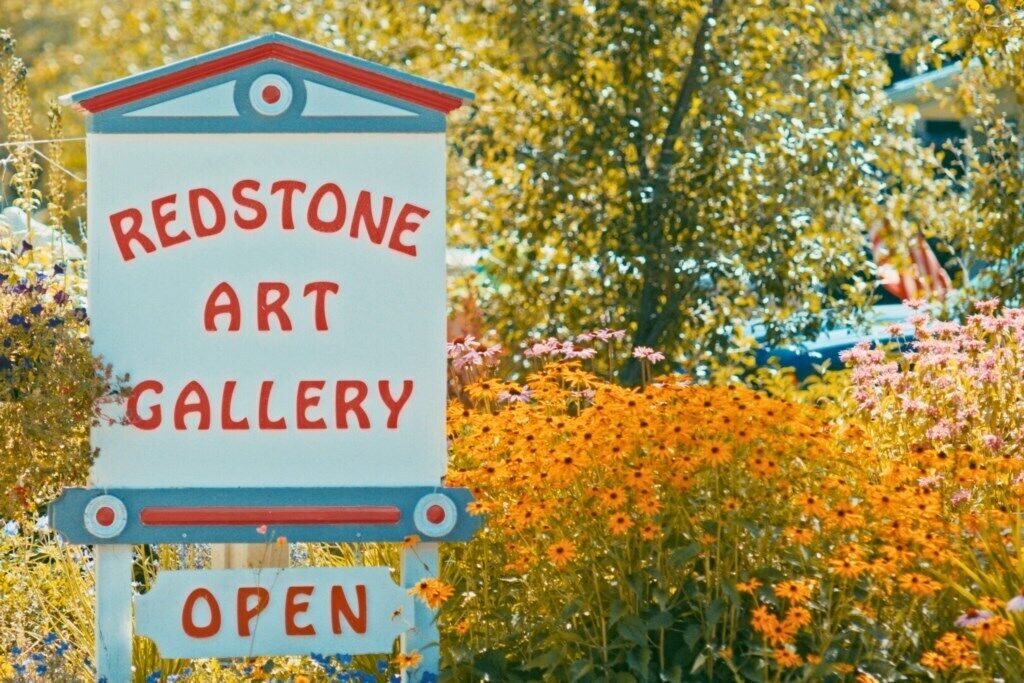 A sign for the Redstone Art Gallery, indicating it is open.