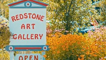 A sign for the Redstone Art Gallery, indicating it is open.