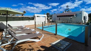 A rooftop swimming pool with lounge chairs and a covered seating area. - Villa Emilia by Best Holidays Fuerteventura (Corralejo)