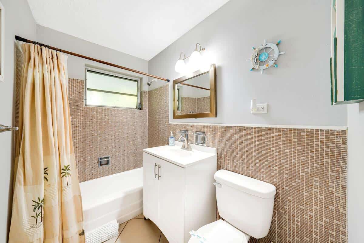 Bathroom with bathtub and shower.