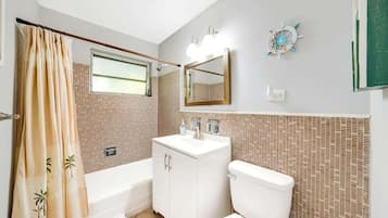 Bathroom with bathtub and shower.
