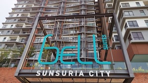 A multi-story building with a sign reading "Bell Suites" and "Sunsuria City". - Bell Suite Sepang KLIA Kota Warisan (Sepang)