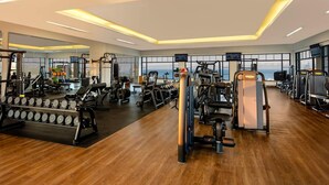 A spacious gym with various exercise equipment, large windows, and a wooden floor. - 3 BR PENTHOUSE AT VISTA ENCANTADA RESORT RANKED #2 IN CABO SAN LUCAS (Cabo San Lucas)