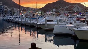 A marina with boats docked, a calm water surface, and buildings in the background. - 3 BR PENTHOUSE AT VISTA ENCANTADA RESORT RANKED #2 IN CABO SAN LUCAS (Cabo San Lucas)
