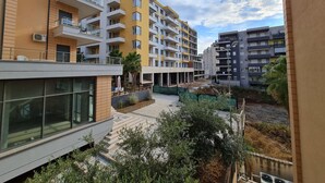 A multi-story residential building with balconies, a covered outdoor area, and a view of the sky. - 2-Bedroom, Sleeps 4, Free Parking (Vlore)
