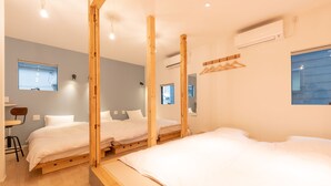A modern room with three wooden beds, a small desk, and a chair. - Gora Base A (Hakone)