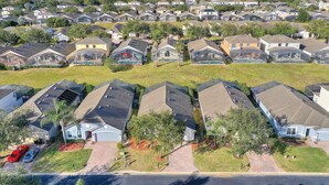 A residential area with multiple houses, some with solar panels, and a few with visible swimming pools. - Drayton Place at Highgate Park by Shine Villas (Davenport)