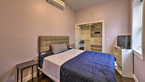 A bedroom with a bed, a bedside table, a wardrobe, and a television. - Boston Apartment < 10 Mi to Top Universities (Revere)