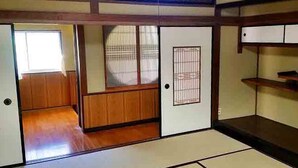 A traditional Japanese room with tatami flooring, sliding doors, and a shoji screen. - Tuwano sou (Tsuwano)