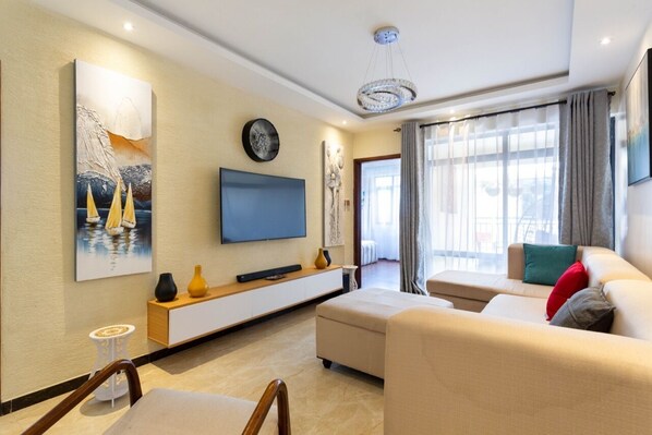 Apartment | Living area | 45-inch Smart TV with digital channels, TV - Stay.Plus Dennis Garden Apartment (Nairobi)
