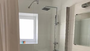A modern bathroom with a shower, a vanity with a mirror, and a window. - CHAMBRE GRAND CONFORT COQUET with PRIVATE JACUZZI (Martignargues)