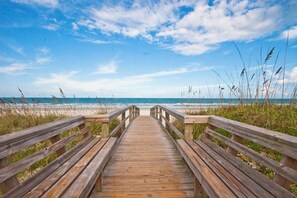 A wooden boardwalk leading to a beach with a clear sky. - Quail Hollow by Distinctive Beach Rentals (St. Augustine)