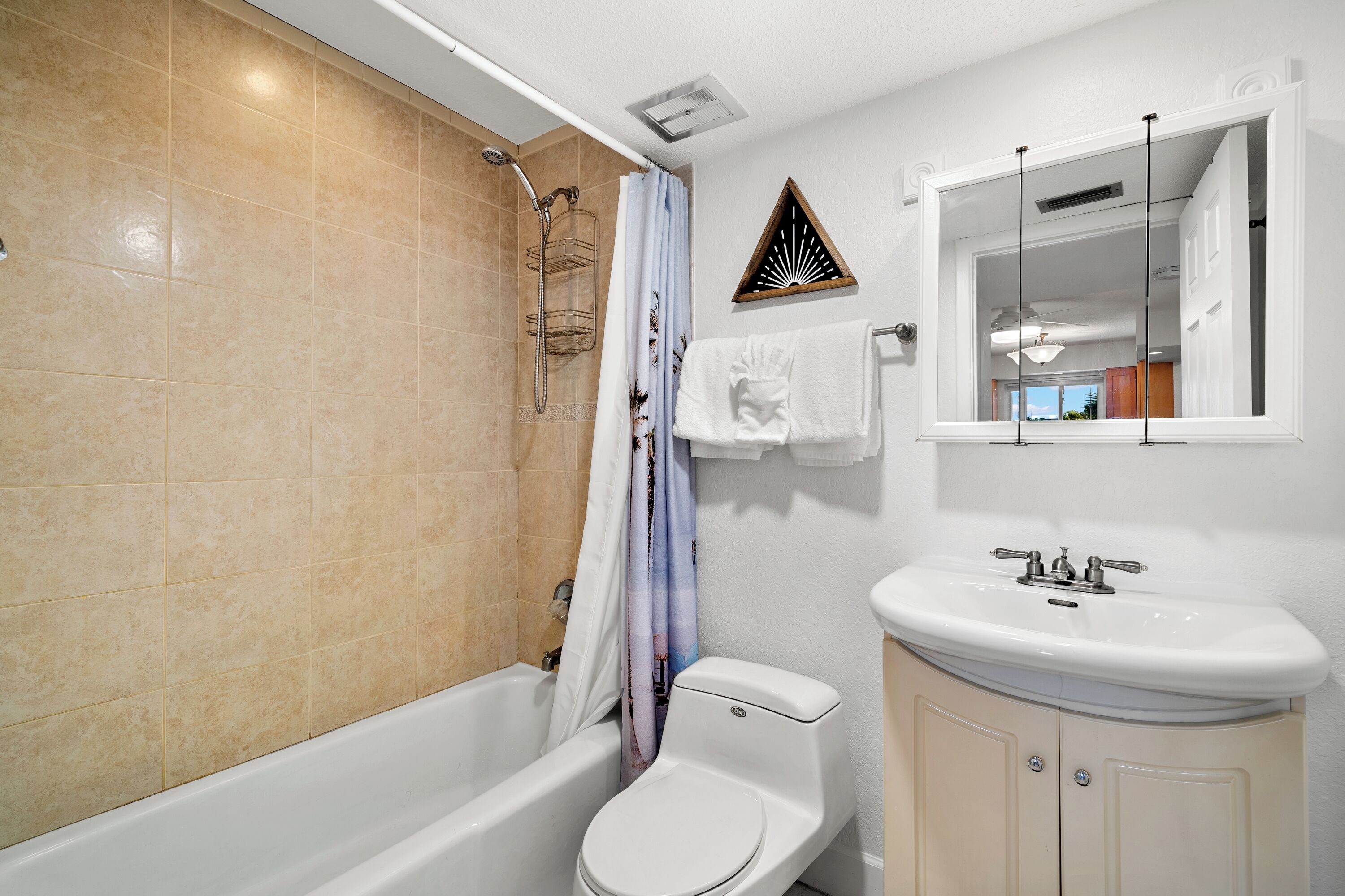 A bathroom with a bathtub, toilet, and sink.