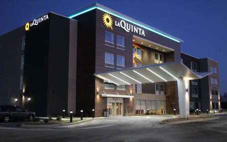 A La Quinta hotel with a modern design, featuring a prominent entrance and a covered walkway.