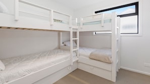 A bunk bed room with a ladder, a window, and a carpeted floor. - OSPREY - MORNINGTON. Walking distance to Mornington's cafe culture. (Mornington)