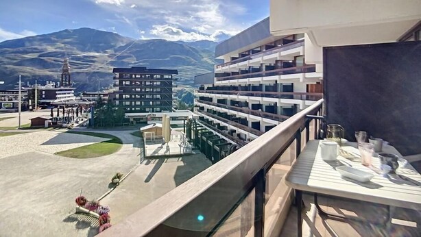 A hotel with multiple floors, outdoor seating, and a view of mountains. - 100m from ski slopes, 3rd floor, balcony, tv, ski locker, 24m², Les Menuires (Les Menuires)